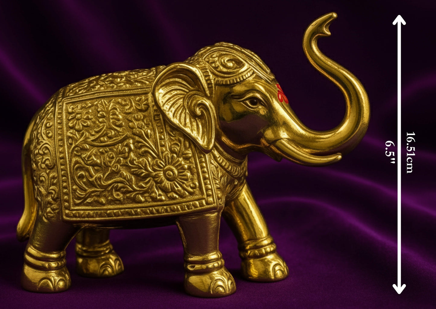 Decorative gold elephant figure on a purple fabric background with measurement details.
