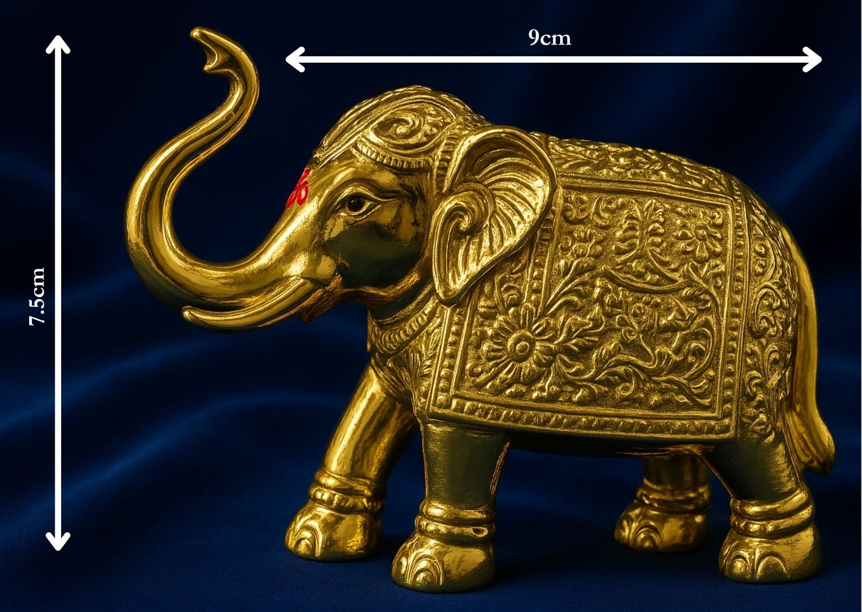 Decorative gold elephant figurine with measurements on a blue background