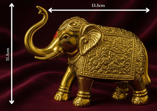 Decorative gold elephant figure with measurements on a dark background